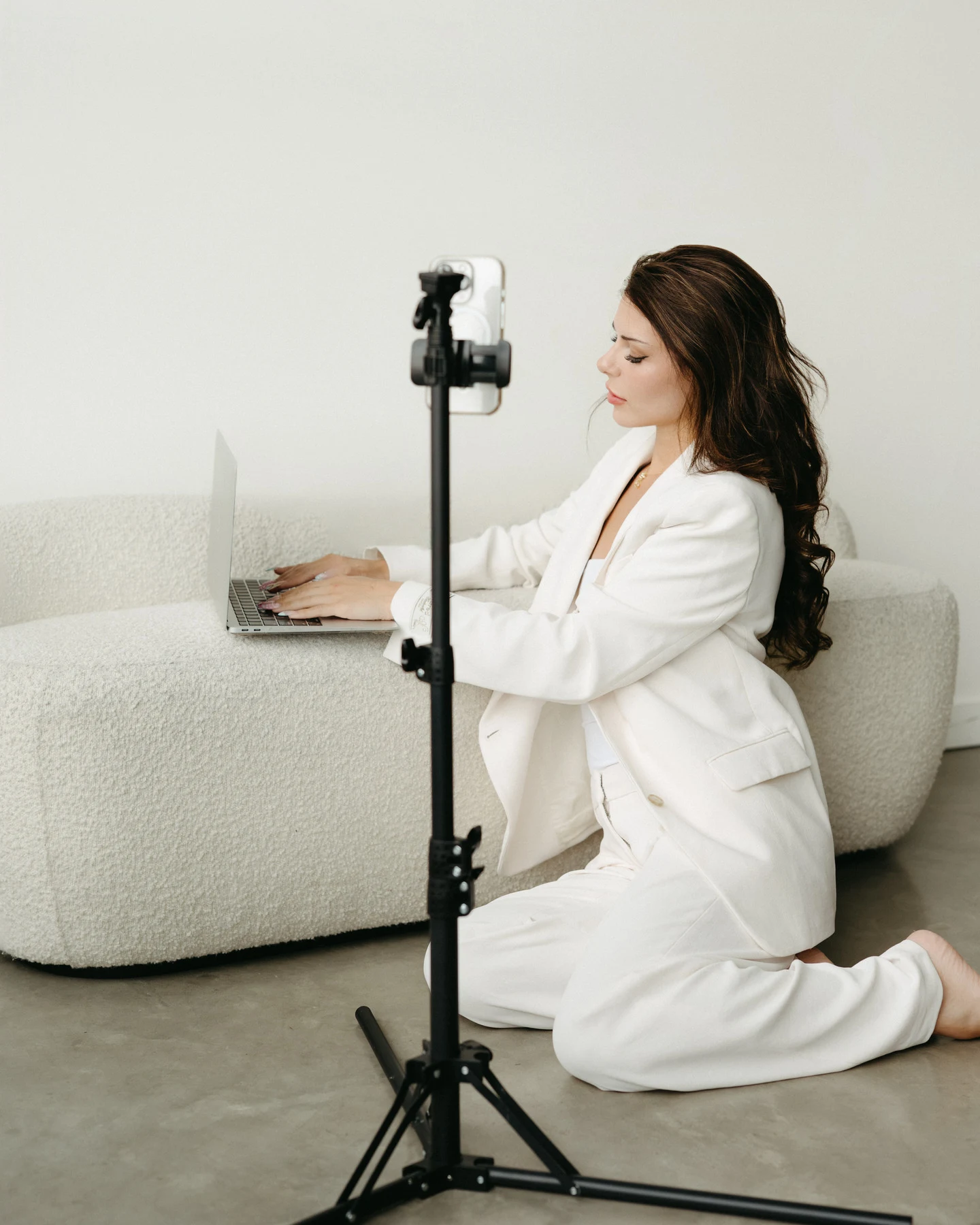 Ashley creating content behind the scenes with phone on tripod